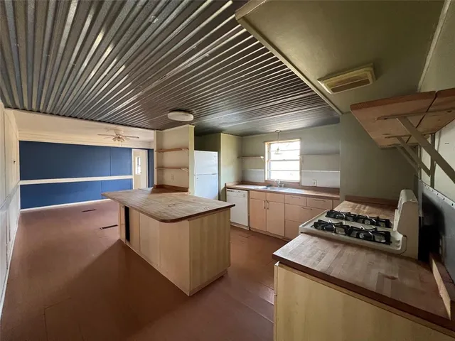 a kitchen with stainless steel appliances granite countertop a stove and a sink