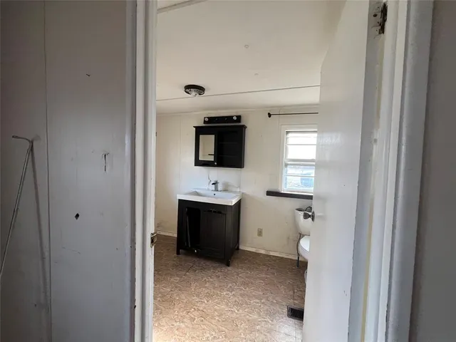 a view of a bathroom with a sink and a mirror