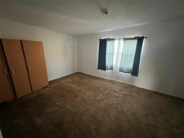 a view of an empty room with windows