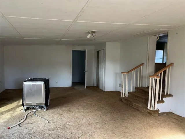 a view of a livingroom with a flesh screen and windows