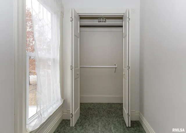 a view of closet with wooden floor