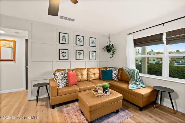 a view of a patio with a table and chairs under an umbrella
