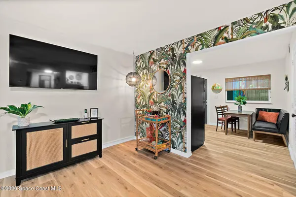 a living room with furniture and painting on the wall