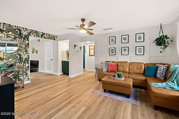 a living room with furniture and wooden floor