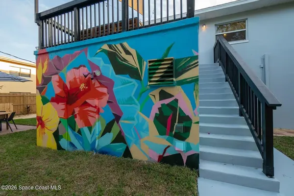 a bed room with a bed a television and a large window