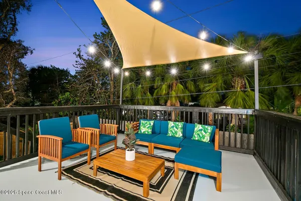 a view of hallway with wooden floor and a potted plant