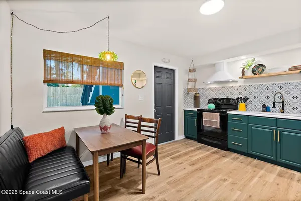 a bedroom with a bed window and a lamp on table
