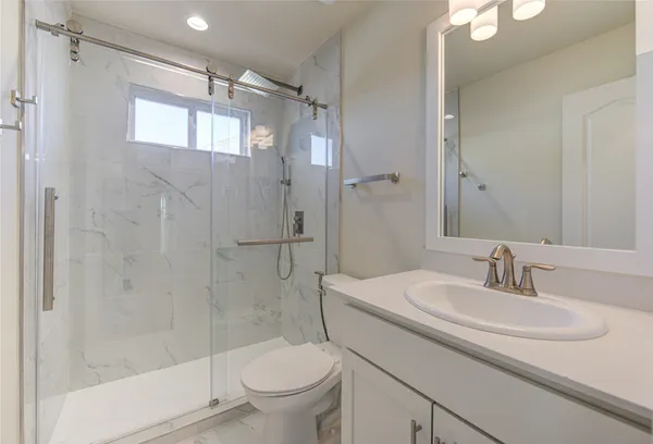 a bathroom with a sink toilet and shower