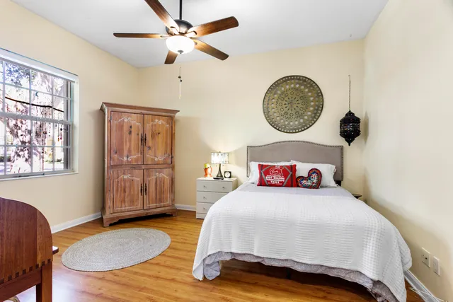 a view of a patio with dining table and chairs under an umbrella