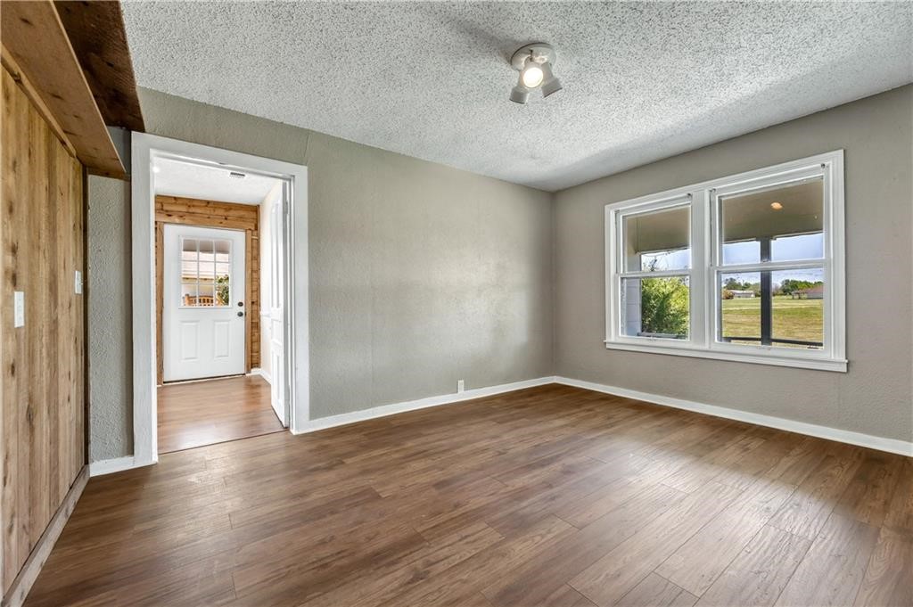 211 Tate Lane Round Rock, TX 78665 - Photo 11 of 40 an empty room with wooden floor and windows