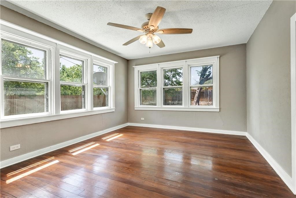 211 Tate Lane Round Rock, TX 78665 - Photo 12 of 40 a view of an empty room with wooden floor and a window