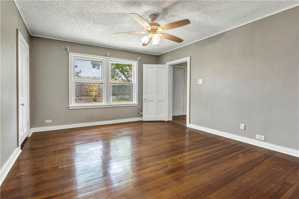 211 Tate Lane Round Rock, TX 78665 - Photo 15 of 40 an empty room with wooden floor and windows