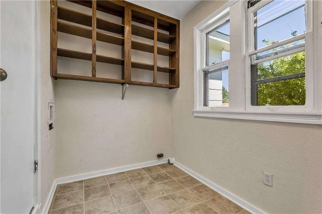 211 Tate Lane Round Rock, TX 78665 - Photo 18 of 40 a view of a room with a large window and wooden floor