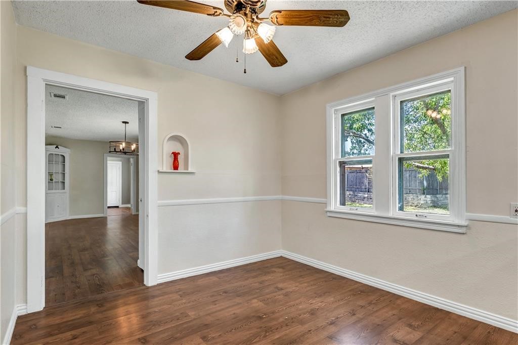 211 Tate Lane Round Rock, TX 78665 - Photo 20 of 40 wooden floor in an empty room with a window