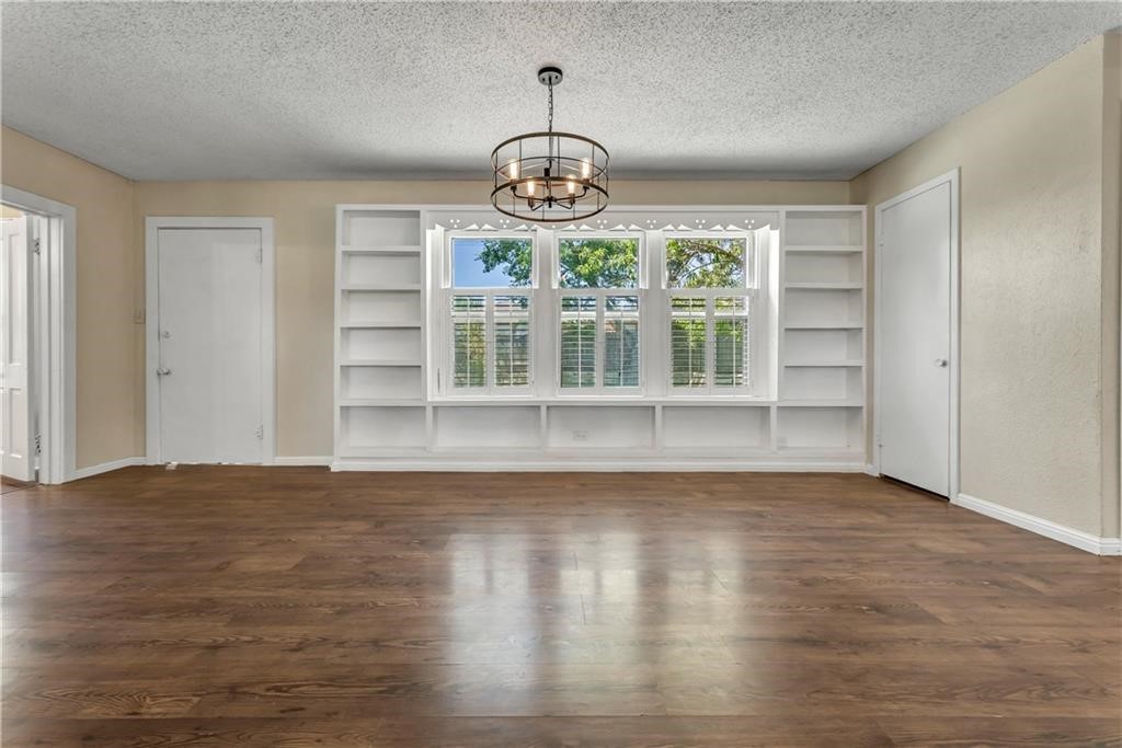 211 Tate Lane Round Rock, TX 78665 - Photo 24 of 40 a view of an empty room with wooden floor and a window