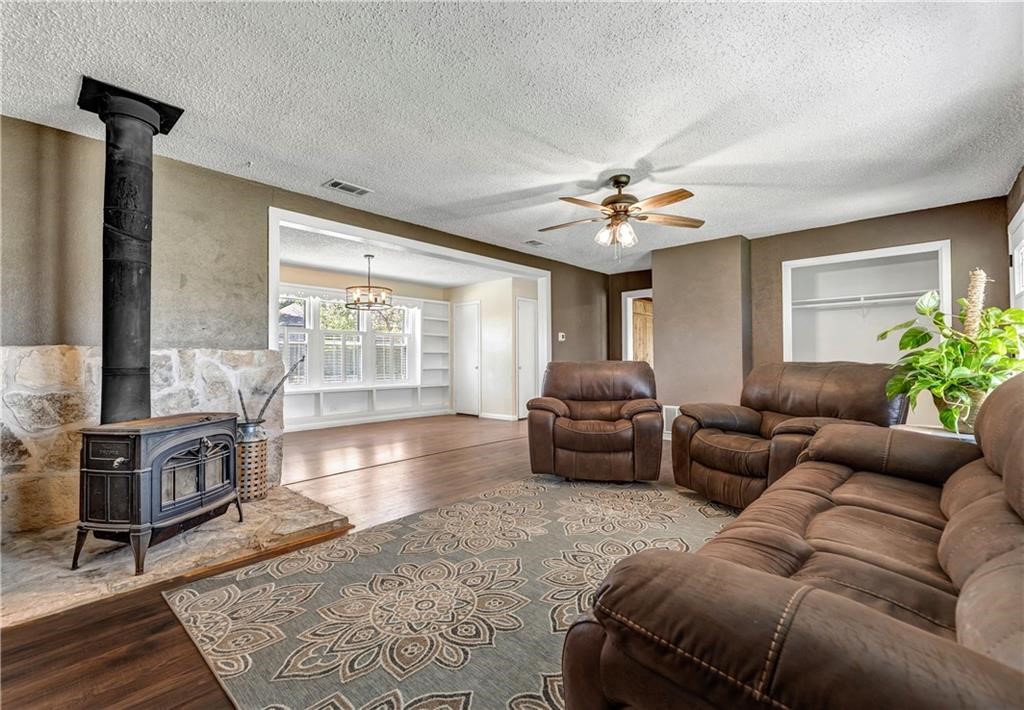 211 Tate Lane Round Rock, TX 78665 - Photo 25 of 40 a living room with furniture and a chandelier