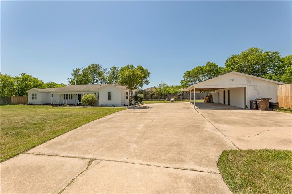 211 Tate Lane Round Rock, TX 78665 - Photo 34 of 40 a front view of a house with a yard and garage