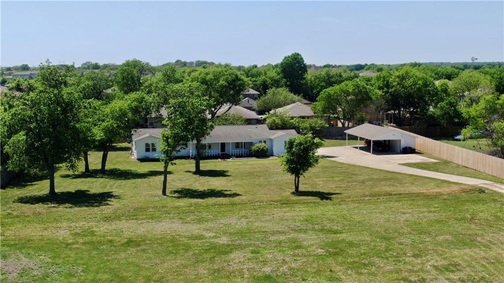211 Tate Lane Round Rock, TX 78665 - Photo 5 of 40 a swimming pool with some trees in the background