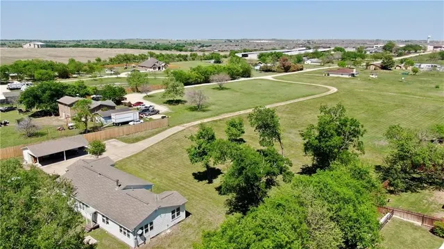 an aerial view of a house with a yard