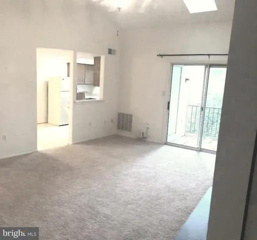 an empty room with a empty space and windows