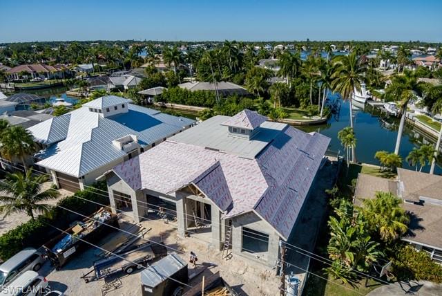 2130 Tarpon Road Naples, FL 34102 - Photo 4 of 12 an aerial view of a house with a swimming pool outdoor seating and yard