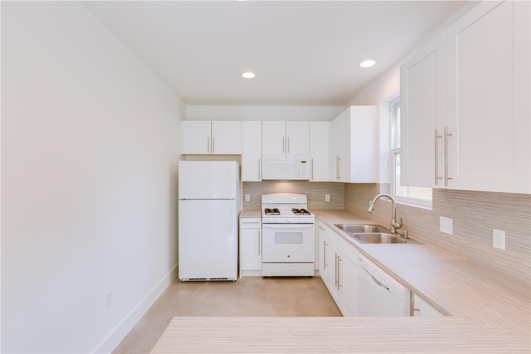 1906 East 17th Street, Unit 1 Austin, TX 78702 - Photo 14 of 33 a kitchen with a sink a stove and cabinets