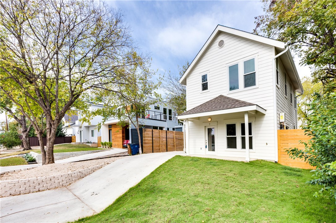 1906 East 17th Street, Unit 1 Austin, TX 78702 - Photo 2 of 33 a view of a white house with a large windows and large trees