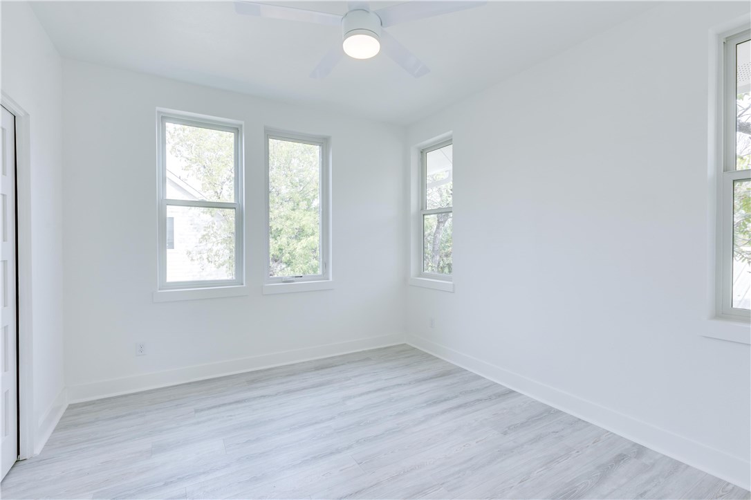 1906 East 17th Street, Unit 1 Austin, TX 78702 - Photo 32 of 33 an empty room with wooden floor and windows