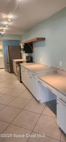a view of a kitchen with white cabinets