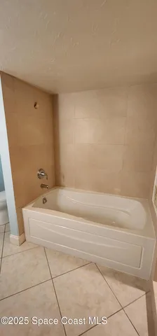 a room with a table chairs and a mirror