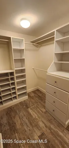 a view of walk in closet with empty racks