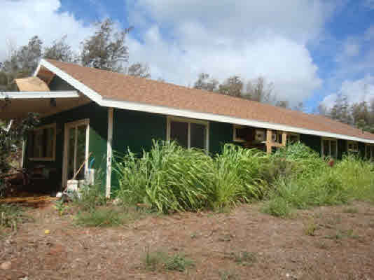 6020 Koolau Road, Unit 56 Kilauea, HI 96754 - Photo 4 of 9 a front view of house with yard and trees around