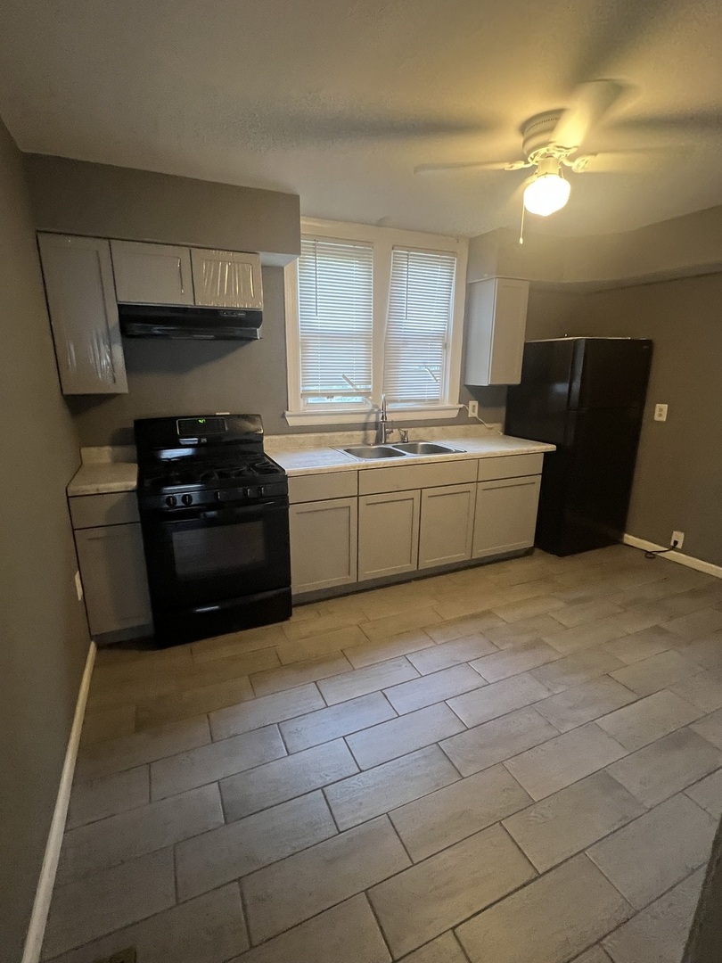 12124 South Normal Avenue Chicago, IL 60628 - Photo 11 of 36 a kitchen with a cabinets and appliances