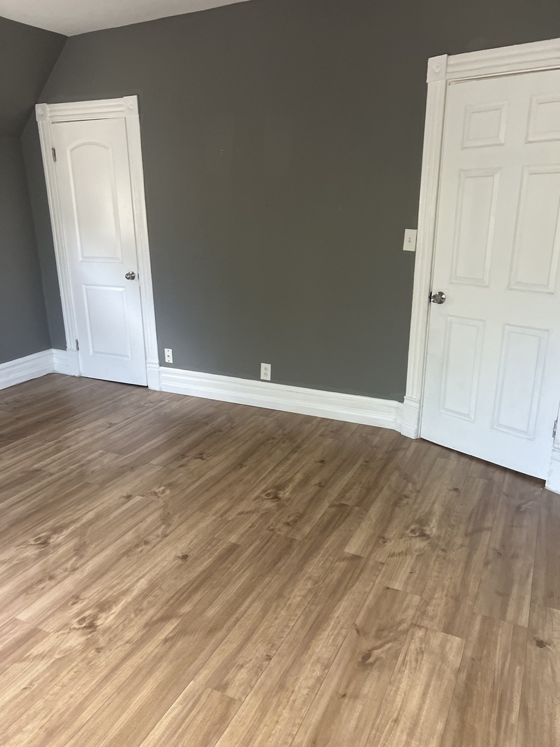 12124 South Normal Avenue Chicago, IL 60628 - Photo 17 of 36 a view of an empty room with wooden floor