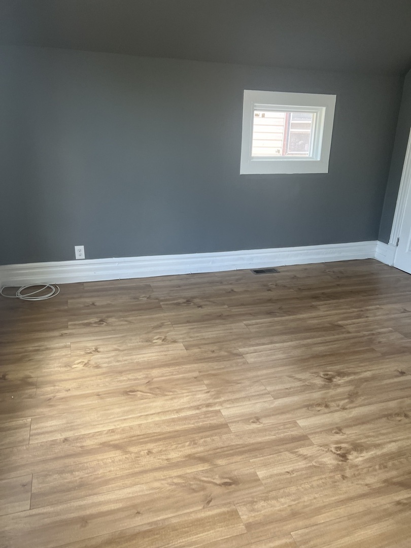 12124 South Normal Avenue Chicago, IL 60628 - Photo 21 of 36 a view of a room with wooden floor