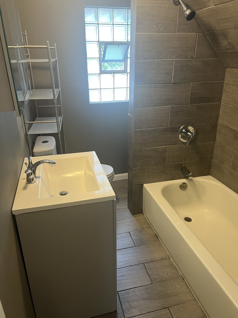 12124 South Normal Avenue Chicago, IL 60628 - Photo 24 of 36 a bathroom with a sink and a tub