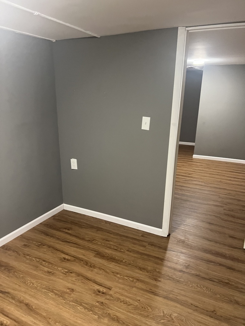 12124 South Normal Avenue Chicago, IL 60628 - Photo 30 of 36 a view of an empty room with wooden floor