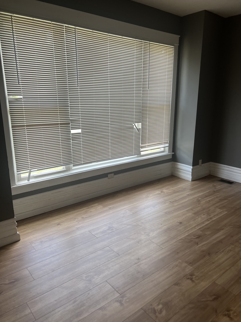 12124 South Normal Avenue Chicago, IL 60628 - Photo 3 of 36 a view of a room with wooden floor and window