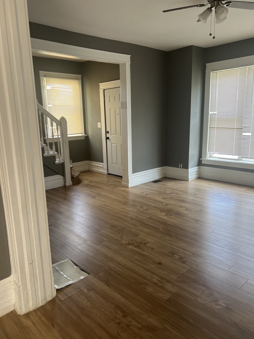 12124 South Normal Avenue Chicago, IL 60628 - Photo 5 of 36 a view of an empty room with wooden floor and a window