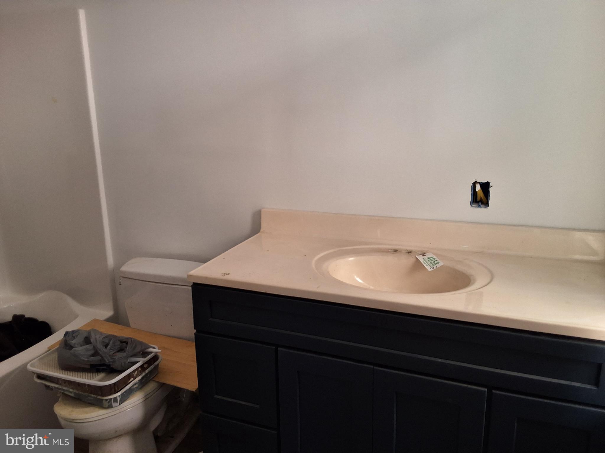 1015 Chestnut Street, Unit 1 Lebanon, PA 17042 - Photo 16 of 20 a bathroom with a sink toilet and vanity