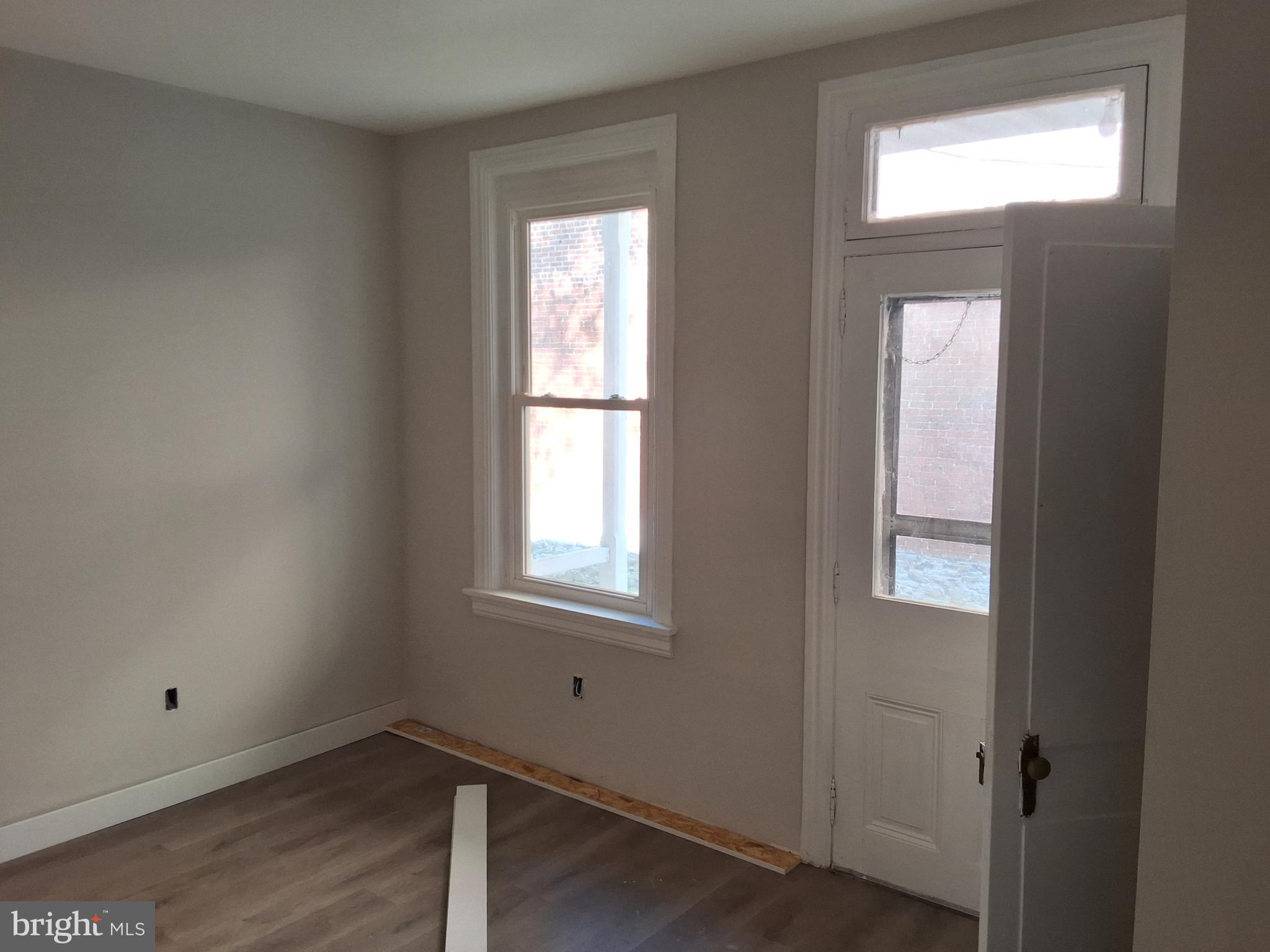 1015 Chestnut Street, Unit 1 Lebanon, PA 17042 - Photo 3 of 20 a view of an empty room with wooden floor and a window