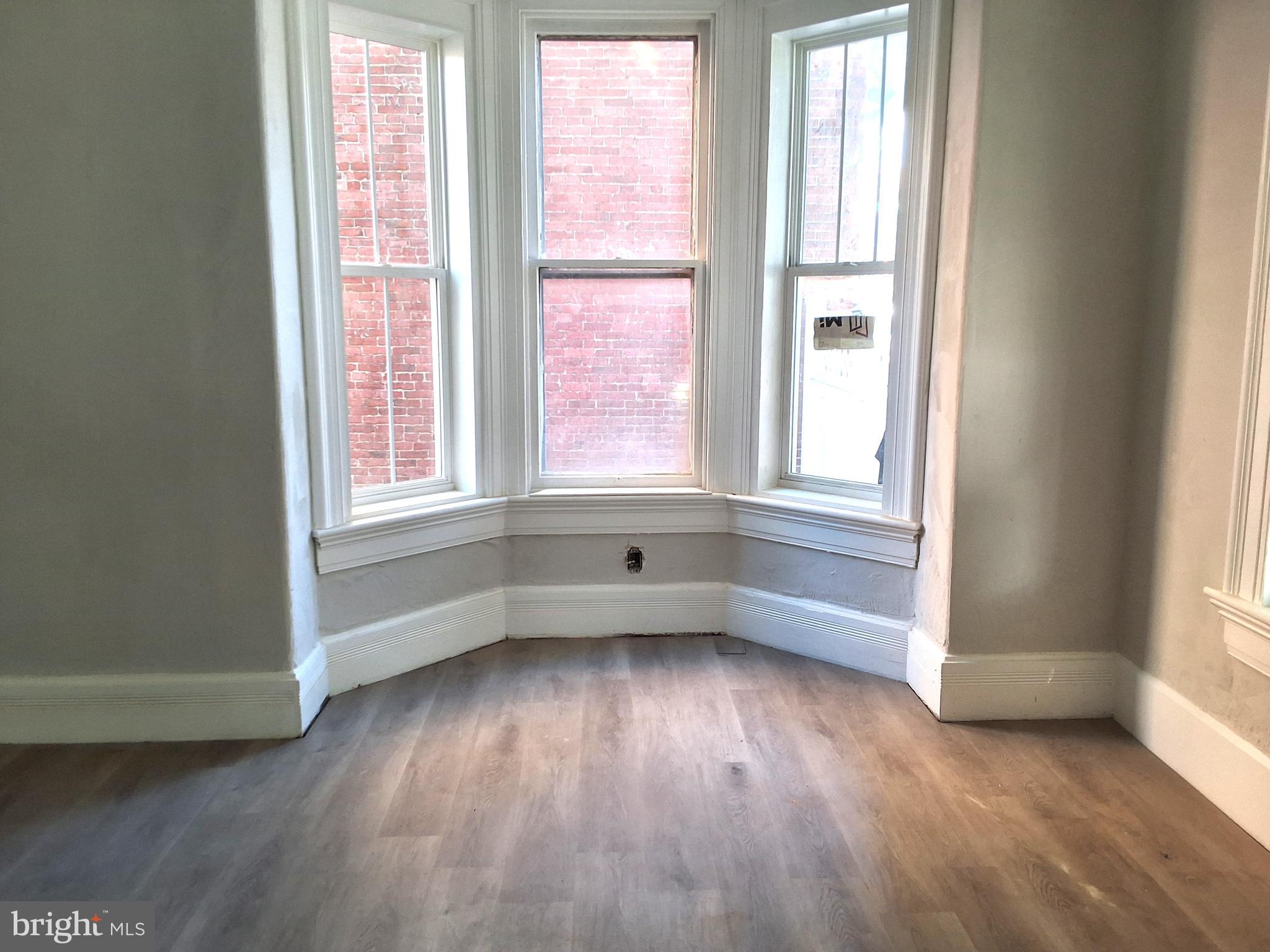 1015 Chestnut Street, Unit 1 Lebanon, PA 17042 - Photo 6 of 20 an empty room with wooden floor and windows
