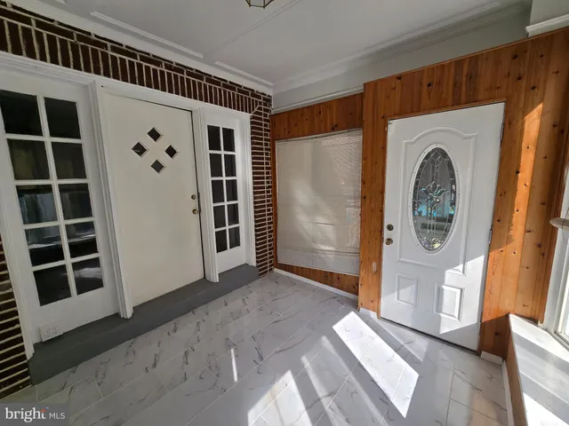 a view of front door with wooden floor