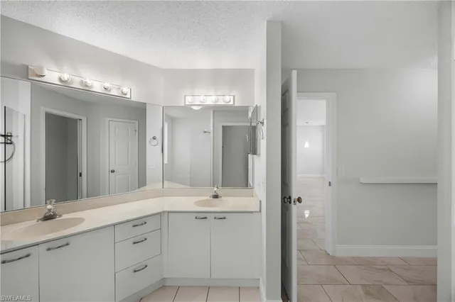a bathroom with a shower sink double and mirror