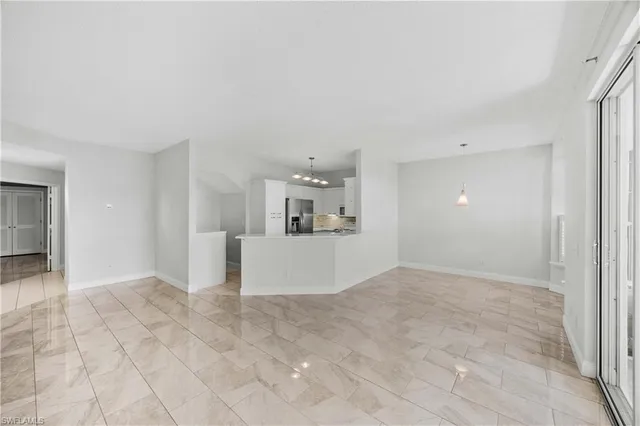 a view of a kitchen with refrigerator and window