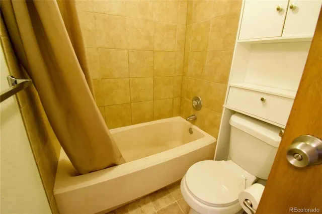 a bathroom with a sink a toilet a tub and a shower