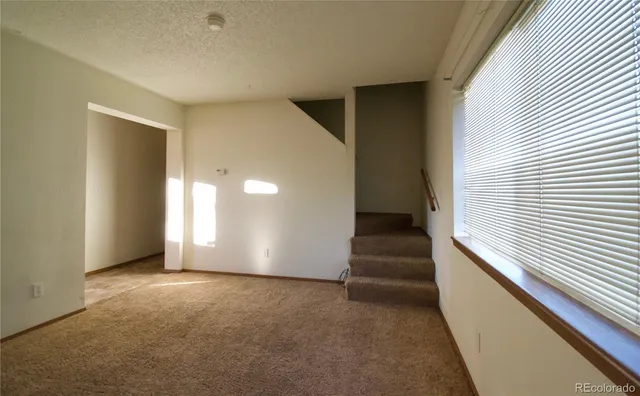 a view of a hallway with stairs