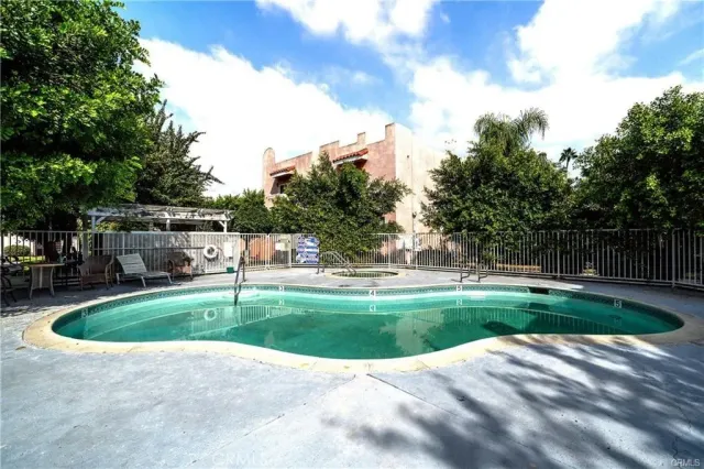 a view of pool with a yard