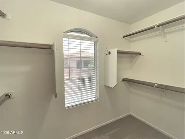 a view of a room with rack on the wall and a window