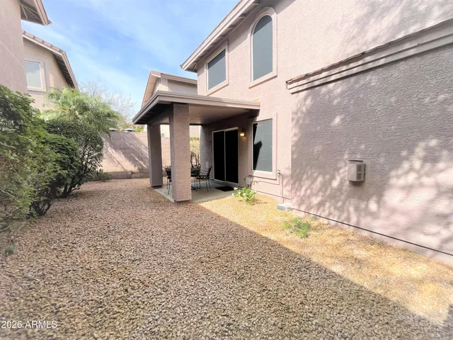 a view of a porch with chairs and backyard
